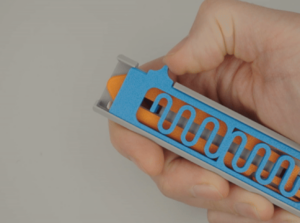 Hand holding a 3D-printed object prototype.