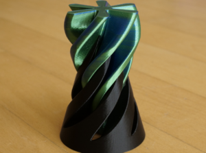3D-printed twisted vase on wooden table.