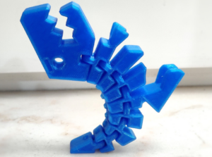 Blue 3D-printed articulated scorpion model.