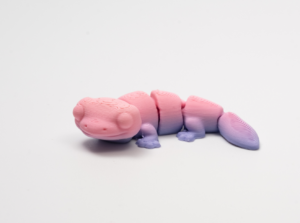 Pink and purple articulated lizard figurine.
